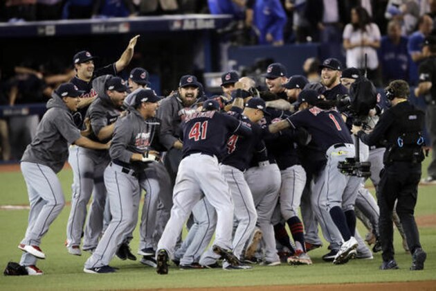 Members of the Cleveland Indians celebrate after their 3-0 win in Game 5 of baseball's American League Championship Series against the Toronto Blue Jays in Toronto, Wednesday, Oct. 19, 2016. (AP Photo/Charlie Riedel) Members of the Cleveland Indians celebrate after their 3-0 win in Game 5 of baseball's American League Championship Series against the Toronto Blue Jays in Toronto, Wednesday, Oct. 19, 2016. (AP Photo/Charlie Riedel)