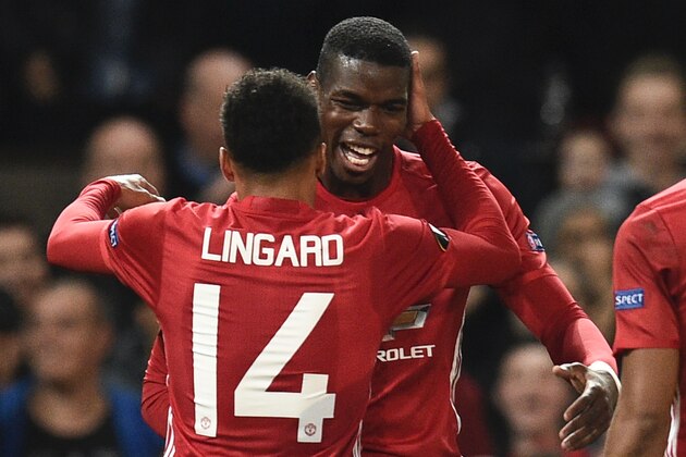 Manchester United's French midfielder Paul Pogba (R) and Manchester United's English midfielder Jesse Lingard (L) celebrate after Pogba scored their third goal during the UEFA Europa League group A football match between Manchester United and Fenerbahce at Old Trafford in Manchester, north west England, on October 20, 2016. / AFP / OLI SCARFF        (Photo credit should read OLI SCARFF/AFP/Getty Images)