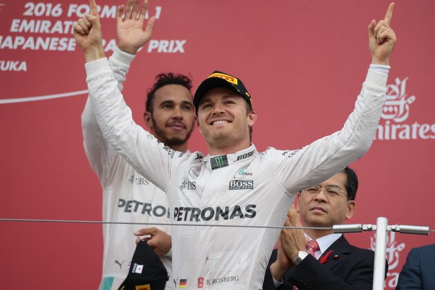 Mercedes AMG Petronas F1 Team's German driver Nico Rosberg (C) celebrates his victory on the podium next to third-placed Mercedes AMG Petronas F1 Team's British driver Lewis Hamilton (L) after the Formula One Japanese Grand Prix at the Suzuka Circuit on October 9, 2016.  / AFP / YUYA SHINO        (Photo credit should read YUYA SHINO/AFP/Getty Images)