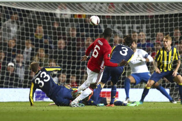 Manchester United's Paul Pogba, centre, scores his sides third goal during the Europa League Group A soccer match between Manchester United and Fenerbahce at Old Trafford stadium in Manchester, England, Thursday, Oct. 20, 2016. (AP Photo/Dave Thompson)