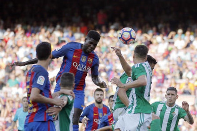 FC Barcelona's Samuel Umtiti, center left, heads for the ball during a Spanish La Liga soccer match between FC Barcelona and Betis at the Camp Nou in Barcelona, Spain, Saturday, Aug. 20, 2016. (AP Photo/Manu Fernandez)