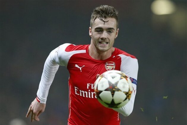 Arsenal's Calum Chambers runs of the ball during the Champions League group D soccer match between Arsenal and Borussia Dortmund at the Emirates stadium in London, Wednesday, Nov. 26, 2014. (AP Photo/Alastair Grant)