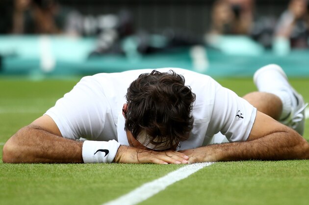 LONDON, ENGLAND - JULY 08:  Roger Federer of Switzerland reacts after he slips during the Men's Singles Semi Final match against Milos Raonic of Canada on day eleven of the Wimbledon Lawn Tennis Championships at the All England Lawn Tennis and Croquet Club on July 8, 2016 in London, England.  (Photo by Clive Brunskill/Getty Images)