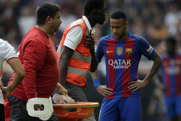 FC Barcelona's Andes Iniesta is stretchered off after an injury during the Spanish La Liga soccer match between Valencia and FC Barcelona at the Mestalla stadium in Valencia, Spain, Saturday, Oct. 22, 2016. (AP Photo/Manu Fernandez)
