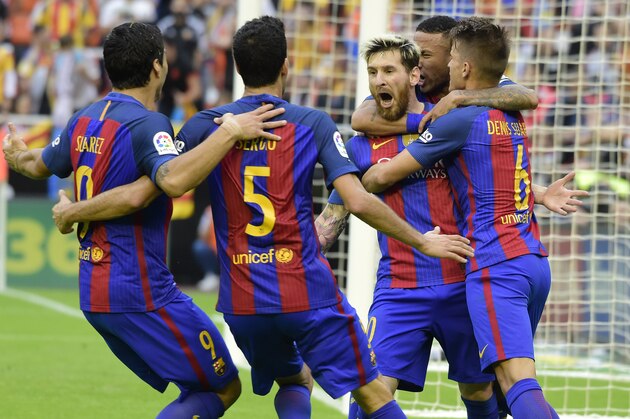 Barcelona's Argentinian forward Lionel Messi (C) celebrates with teammates after scoring during the Spanish league football match Valencia CF vs FC Barcelona at the Mestalla stadium in Valencia on October 22, 2016. / AFP / JOSE JORDAN        (Photo credit should read JOSE JORDAN/AFP/Getty Images)