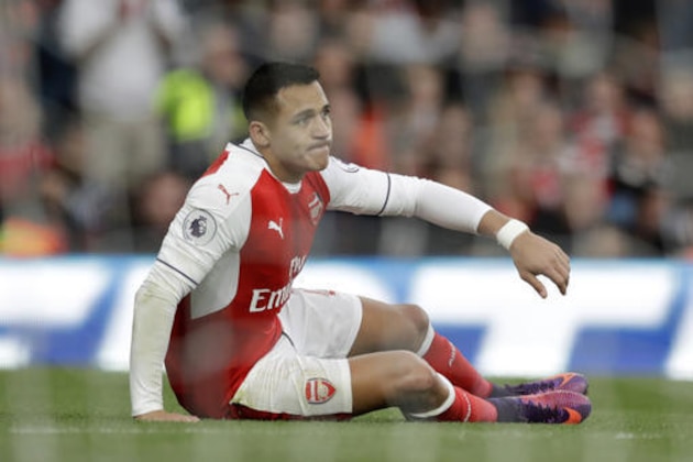 Arsenal's Alexis Sanchez is seen through the net as he gets up after a scoring chance during the English Premier League soccer match between Arsenal and Middlesbrough at the Emirates Stadium in London, Saturday, Oct. 22, 2016. (AP Photo/Matt Dunham)