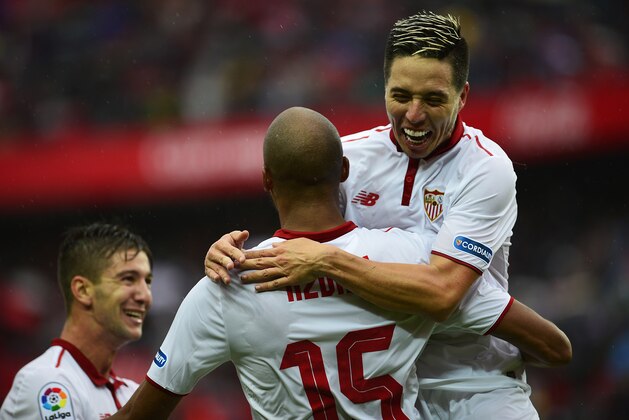 Sevilla's French midfielder Steven N'Zonzi (back) celebrates a goal with Sevilla's French midfielder Samir Nasri (R) during the Spanish league football match between Sevilla FC and Club Atletico de Madrid at the Ramon Sanchez Pizjuan stadium in Sevilla on October 23, 2016. / AFP / CRISTINA QUICLER        (Photo credit should read CRISTINA QUICLER/AFP/Getty Images)