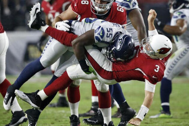 Arizona Cardinals quarterback Carson Palmer (3) is hit after the throw by Seattle Seahawks defensive end Frank Clark (55) during the first half of a football game, Sunday, Oct. 23, 2016, in Glendale, Ariz. (AP Photo/Ross D. Franklin)