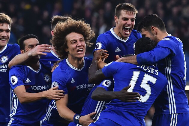 Chelsea players (L-) Chelsea's Spanish defender Marcos Alonso, Chelsea's Spanish midfielder Pedro, Chelsea's English defender Gary Cahill, Chelsea's Brazilian defender David Luiz, Chelsea's Spanish defender Cesar Azpilicueta, Chelsea's French midfielder N'Golo Kante, Chelsea's Nigerian midfielder Victor Moses and Chelsea's Brazilian-born Spanish striker Diego Costa celebrate after Chelsea's French midfielder N'Golo Kante scored their fourth goal during the English Premier League football match between Chelsea and Manchester United at Stamford Bridge in London on October 23, 2016. / AFP / GLYN KIRK / RESTRICTED TO EDITORIAL USE. No use with unauthorized audio, video, data, fixture lists, club/league logos or 'live' services. Online in-match use limited to 75 images, no video emulation. No use in betting, games or single club/league/player publications.  /         (Photo credit should read GLYN KIRK/AFP/Getty Images)