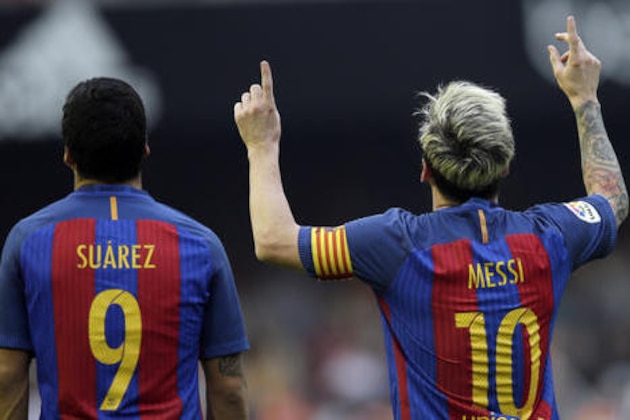 FC Barcelona's Lionel Messi, right, celebrates after scoring a penalty during the Spanish La Liga soccer match between Valencia and FC Barcelona at the Mestalla stadium in Valencia, Spain, Saturday, Oct. 22, 2016. (AP Photo/Manu Fernandez)