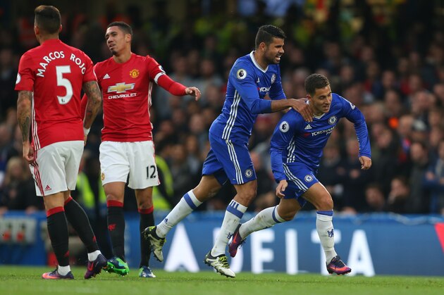 LONDON, ENGLAND - OCTOBER 23: Eden Hazard of Chelsea celebrates after he scores to make it 3-0 with Diego Costa of Chelsea past a dejected looking Chris Smalling and  Marcos Rojo of Manchester United during the Premier League match between Chelsea and Manchester United at Stamford Bridge on October 23, 2016 in London, England. (Photo by Catherine Ivill - AMA/Getty Images)