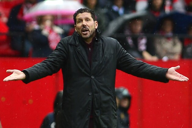 Atletico Madrid's Argentinian coach Diego Simeone gestures from the sideline during the Spanish league football match between Sevilla FC and Club Atletico de Madrid at the Ramon Sanchez Pizjuan stadium in Sevilla on October 23, 2016. / AFP / CRISTINA QUICLER        (Photo credit should read CRISTINA QUICLER/AFP/Getty Images)