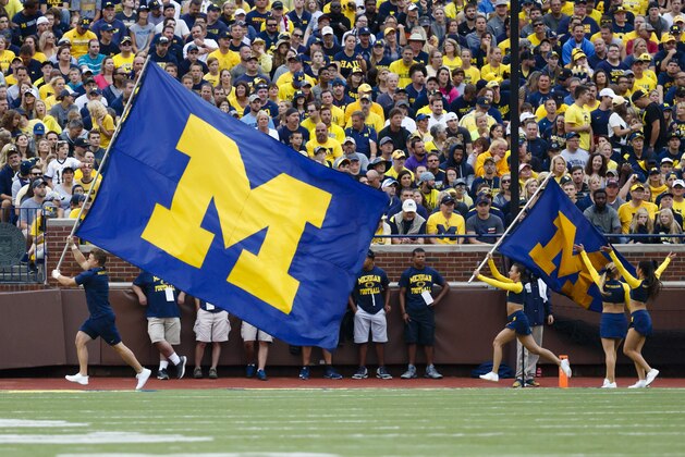 Sep 10, 2016; Ann Arbor, MI, USA; Michigan Wolverines cheerleaders run with flags after a score against the UCF Knights at Michigan Stadium. Mandatory Credit: Rick Osentoski-USA TODAY Sports
