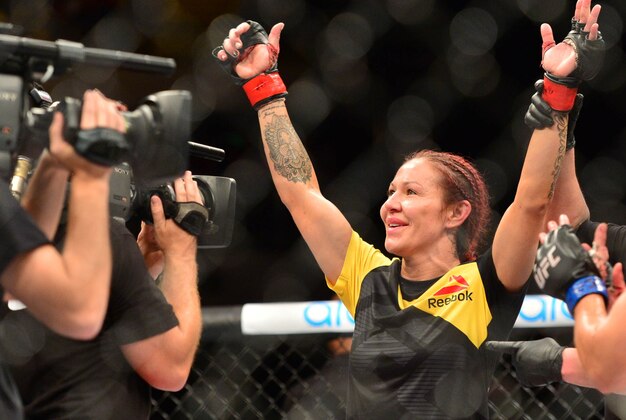Sep 24, 2016; Brasilia, Brazil;  Cris Cyborg (red gloves) celebrates defeating Lina Lansberg (blue gloves) during UFC Fight Night at Nilson Nelson Gymnasium. Mandatory Credit: Jason Silva-USA TODAY Sports