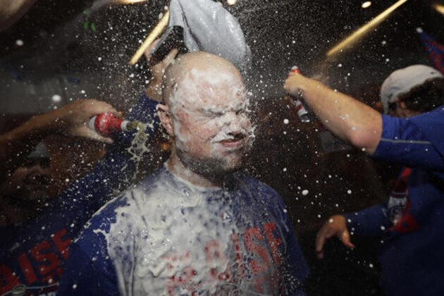 Chicago Cubs' Jon Lester is doused as players celebrate after Game 6 of the National League baseball championship series against the Los Angeles Dodgers, Saturday, Oct. 22, 2016, in Chicago. The Cubs won 5-0 to win the series and advance to the World Series against the Cleveland Indians. (AP Photo/David J. Phillip)
