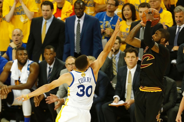 Cleveland Cavaliers guard Kyrie Irving (R) makes a three-point shot over Golden State Warriors guard Stephen Curry to take the lead in the final moments of the fourth quarter in Game 7 of the NBA Finals on June 19, 2016 in Oakland, California.
Powered by an amazing effort from LeBron James, the Cleveland Cavaliers completed the greatest comeback in NBA Finals history, dethroning defending champion Golden State 93-89 to capture their first NBA title. The Cavaliers won the best-of-seven series 4-3 to claim the first league crown in their 46-season history and deliver the first major sports champion to Cleveland since the 1964 NFL Browns, ending the longest such title drought for any American city.
 / AFP / Beck Diefenbach        (Photo credit should read BECK DIEFENBACH/AFP/Getty Images)