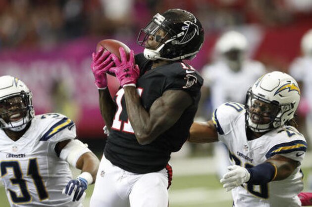 Atlanta Falcons wide receiver Julio Jones (11) makes the catch between San Diego Chargers free safety Dwight Lowery (20) and San Diego Chargers free safety Adrian Phillips (31) during the first half of an NFL football game, Sunday, Oct. 23, 2016, in Atlanta. (AP Photo/John Bazemore)
