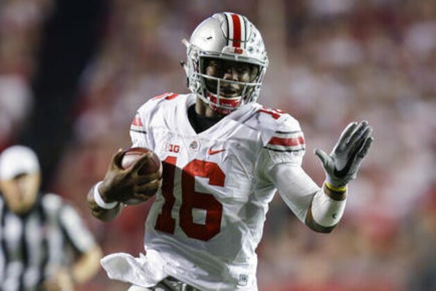 FILE - In this Oct. 15, 2016, file photo, Ohio State quarterback J.T. Barrett (16) scrambles against Wisconsin during the first half of an NCAA college football game, in Madison, Wis. Barrett was big-time in prime time last week and now he has two more showcase games in the next three weeks to boost his Heisman Trophy hopes.  (AP Photo/Andy Manis, File)