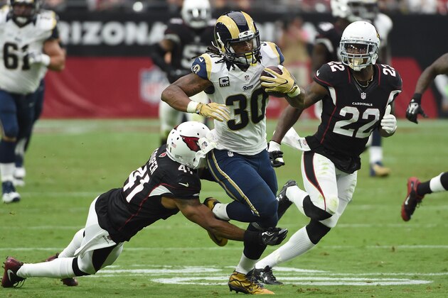 GLENDALE, AZ - OCTOBER 02:  Running back Todd Gurley #30 of the Los Angeles Rams rushes the football against defensive back Marcus Cooper #41 and strong safety Tony Jefferson #22 of the Arizona Cardinals during the second half of the NFL game at University of Phoenix Stadium on October 2, 2016 in Glendale, Arizona.  (Photo by Norm Hall/Getty Images)