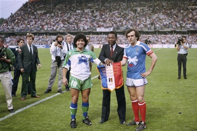 Soccer stars Argentine’s Diego Maradona, left, Pele of Brazil, center, and France’s Michel Platini pose shaking hands during Platini’s jubilee at Nancy stadium, Eastern France, Monday, May 23, 1988 as they celebrate Platini’s one-year-old retirement in a match opposing a selection of international soccer stars to France’s best players. (AP Photo/Lionel Cironneau)