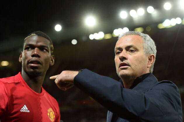 Manchester United's Portuguese manager Jose Mourinho (R) gestures to Manchester United's French midfielder Paul Pogba as he arrives on the pitch ahead of the UEFA Europa League group A football match between Manchester United and Zorya Luhansk at Old Trafford stadium in Manchester, north-west England, on September 29, 2016. / AFP / PAUL ELLIS        (Photo credit should read PAUL ELLIS/AFP/Getty Images)