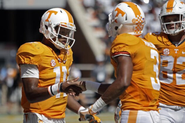FILE - In this Sept. 17, 2016, file photo, Tennessee quarterback Joshua Dobbs (11) congratulates wide receiver Josh Malone (3) after scoring a touchdown in the second half of an NCAA college football game against Ohio in Knoxville, Tenn. Tennessee coach Butch Jones is in his fourth season on the job and believes his Volunteers have never faced a defense quite as good as the one Florida brings to Neyland Stadium this weekend. (AP Photo/Wade Payne, File)