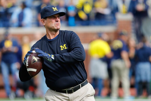 ANN ARBOR, MI - OCTOBER 01: Michigan Wolverines head football coach Jim Harbaugh warms up prior to the start of the game against the Wisconsin Badgers at Michigan Stadium on October 1, 2016 in Ann Arbor, Michigan. Michigan defeated Wisconsin 14-7. (Photo by Leon Halip/Getty Images)