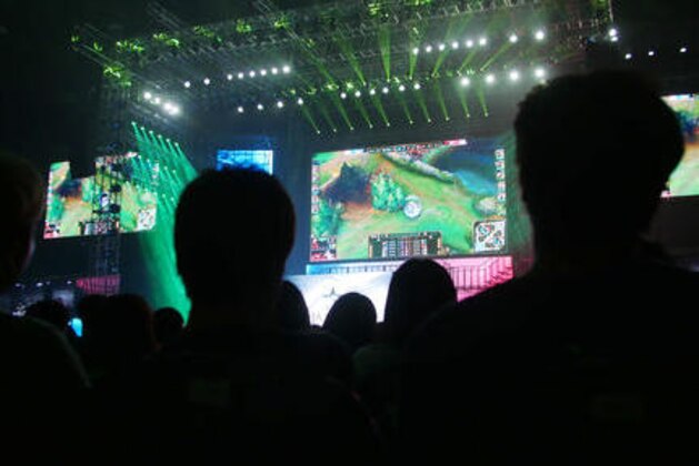 In this Aug. 20, 2016 photo, crowd watch the screens showing the 2016 Coca-Cola League of Legend Summer Final match between Rox Tigers and KT Rolster at Jamsil gymnasium in Seoul, South Korea. South Korea started the e-sports industry in the early 2000s, and it continues to be a world leader in competitive gaming. There are not only professional video game players, but also broadcasting channels and professional leagues for different kinds of games. South Koreans can easily watch professional gamers playing on both television and the internet. (AP Photo/Jungho Choi)