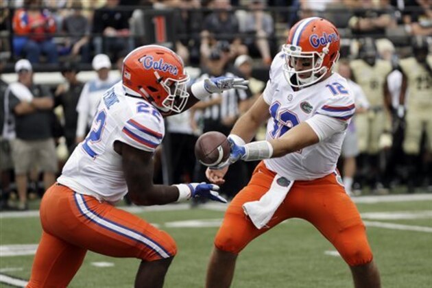 Florida quarterback Austin Appleby (12) hands off to running back Lamical Perine (22) in the second half of an NCAA college football game Saturday, Oct. 1, 2016, in Nashville, Tenn. Florida won 13-6. (AP Photo/Mark Humphrey)