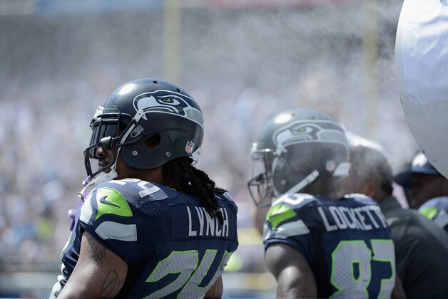 SAN DIEGO, CA - SEPTEMBER 14:  Running back Marshawn Lynch #24 and wide receiver Ricardo Lockette #83 of the Seattle Seahawks stand in front of cooling fans on the sideline during a game against the San Diego Chargers at Qualcomm Stadium on September 14, 2014 in San Diego, California.  (Photo by Donald Miralle/Getty Images)