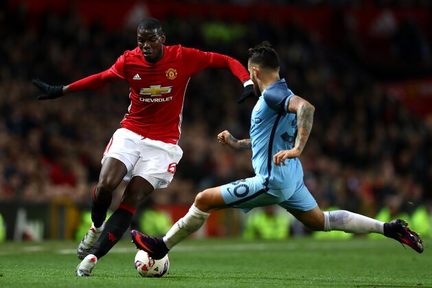 MANCHESTER, ENGLAND - OCTOBER 26: Paul Pogba of Manchester United (L) attempts to take the ball past Nicolas Otamendi of Manchester City (R) during the EFL Cup fourth round match between Manchester United and Manchester City at Old Trafford on October 26, 2016 in Manchester, England.  (Photo by Michael Steele/Getty Images)