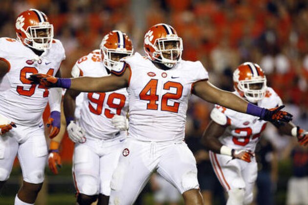 FILE - In this Sept. 3, 2016, file photo, Clemson defensive lineman Christian Wilkins celebrates after a Clemson sack of Auburn quarterback Jeremy Johnson during the first half of an NCAA college football game om Auburn, Ala. Four ACC teams rank 8th to 11th nationally in FBS total defense with Clemson, Louisville and Virginia Tech ranked and thinking about winning the conference. Several other schools have been impressive as well, helping to show the conference is about more than dynamic quarterbacks such as Louisville's Lamar Jackson and Clemson's Deshaun Watson. (AP Photo/Brynn Anderson, File) FILE - In this Sept. 3, 2016, file photo, Clemson defensive lineman Christian Wilkins celebrates after a Clemson sack of Auburn quarterback Jeremy Johnson during the first half of an NCAA college football game om Auburn, Ala. Four ACC teams rank 8th to 11th nationally in FBS total defense with Clemson, Louisville and Virginia Tech ranked and thinking about winning the conference. Several other schools have been impressive as well, helping to show the conference is about more than dynamic quarterbacks such as Louisville's Lamar Jackson and Clemson's Deshaun Watson. (AP Photo/Brynn Anderson, File)
