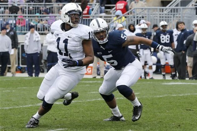 Penn State linebacker Nyeem Wartman (5) defends against tight end Brent Wilkerson in the first half of the Spring NCAA football scrimmage on Saturday, April 20, 2013 in State College, Pa. (AP Photo/Keith Srakocic)