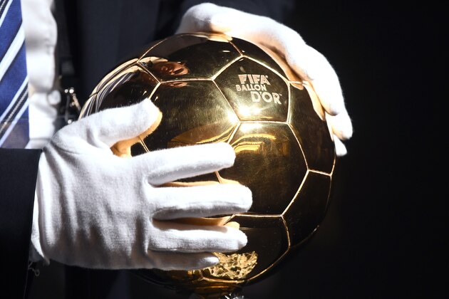 A man places the 2015 FIFA Ballon dOr trophy ahead of the award ceremony at the Kongresshaus in Zurich on January 11, 2016.   AFP PHOTO / OLIVIER MORIN / AFP / OLIVIER MORIN        (Photo credit should read OLIVIER MORIN/AFP/Getty Images)