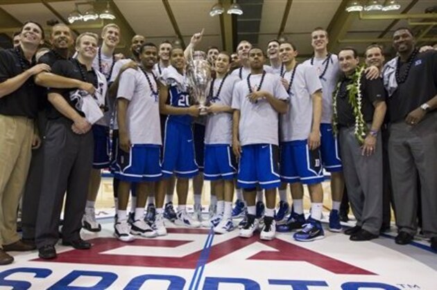 Duke head coach Mike Krzyzewski, second from the right, and the Duke Blue Devils basketball team show off their 2011 Maui Invitational first place trophy after an NCAA college basketball game Wednesday, Nov. 23, 2011, in Lahaina, Hawaii. Duke defeated Kansas 68-61 to win the 2011 Maui Invitationl. (AP Photo/Eugene Tanner)