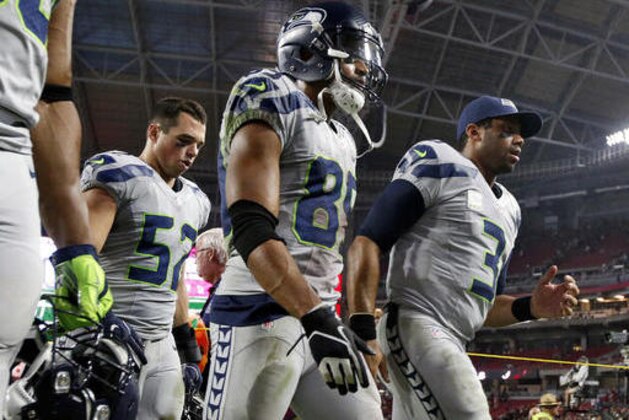 Seattle Seahawks quarterback Russell Wilson (3), wide receiver Doug Baldwin (89) and middle linebacker Brock Coyle (52) leave the field after an NFL football game against the Arizona Cardinals, Sunday, Oct. 23, 2016, in Glendale, Ariz. The game ended in overtime in a 6-6 tie. (AP Photo/Ross D. Franklin)