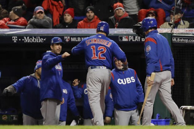 Chicago Cubs' Kyle Schwarber celebrates in the dugout after gets walked in during the fifth inning of Game 2 of the Major League Baseball World Series against the Cleveland Indians Wednesday, Oct. 26, 2016, in Cleveland. (AP Photo/Matt Slocum)