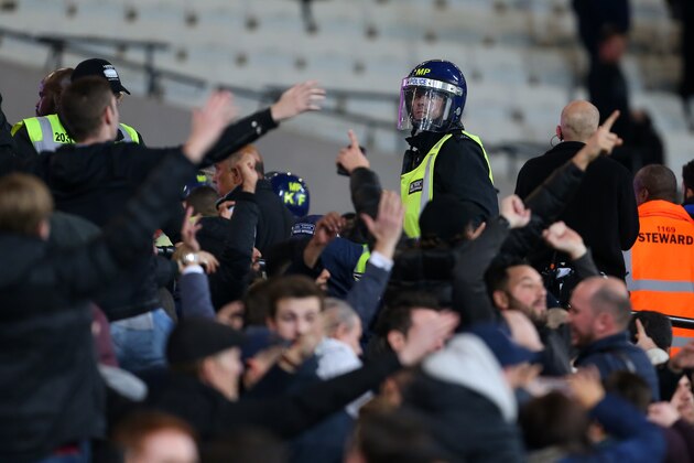 LONDON, ENGLAND - OCTOBER 26: A police officer in riot uniform keeps an eye on the fans as they taunt each other during the EFL Cup fourth round match between West Ham and Chelsea at The London Stadium on October 26, 2016 in London, England. (Photo by Catherine Ivill - AMA/Getty Images)