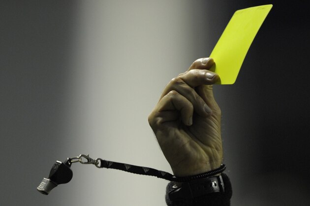 Colombian referee Jose Buitrago shows the yellow card to Brazil's Fluminense defender Carlinhos (not in frame) during their Copa Libertadores 2012 quarterfinals first leg football match against Argentina's Boca Juniors at 'La Bombonera' stadium in Buenos Aires, Argentina, on May 17, 2012. AFP PHOTO / Juan Mabromata        (Photo credit should read JUAN MABROMATA/AFP/Getty Images)
