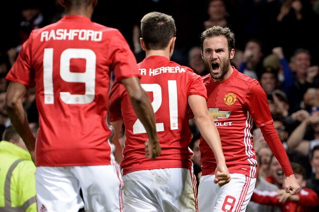 Manchester United's Spanish midfielder Juan Mata (R) celebrates with teammates after scoring the opening goal of the EFL (English Football League) Cup fourth round match between Manchester United and Manchester City at Old Trafford in Manchester, north west England on October 26, 2016. / AFP / Oli SCARFF / RESTRICTED TO EDITORIAL USE. No use with unauthorized audio, video, data, fixture lists, club/league logos or 'live' services. Online in-match use limited to 75 images, no video emulation. No use in betting, games or single club/league/player publications.  /         (Photo credit should read OLI SCARFF/AFP/Getty Images)