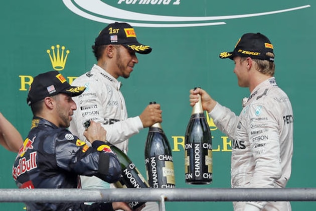 Mercedes driver Lewis Hamilton, center, of Britain, Mercedes driver Nico Rosberg, right, of Germany, and Red Bull driver Daniel Ricciardo, of Australia, celebrate after the Formula One U.S. Grand Prix auto race at the Circuit of the Americas, Sunday, Oct. 23, 2016, in Austin, Texas. Hamilton won the race, Rosberg finished second and Ricciardo finished third. (AP Photo/Tony Gutierrez)