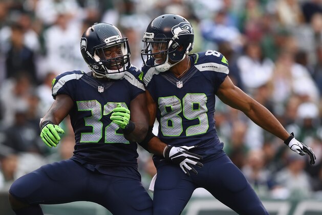 EAST RUTHERFORD, NJ - OCTOBER 02:  Christine Michael #32 of the Seattle Seahawks celebrates his fourth quarter touchdown with teammate Doug Baldwin #89 against the New York Jets at MetLife Stadium on October 2, 2016 in East Rutherford, New Jersey.  (Photo by Elsa/Getty Images)