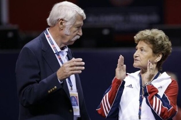 Bela Karolyi, left, and his wife Marta Karolyi talk on the arena floor before the start of the preliminary round of the women's Olympic gymnastics trials, Friday, June 29, 2012, in San Jose, Calif. (AP Photo/Gregory Bull)