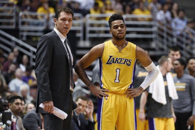 Los Angeles Lakers coach Luke Walton, left, talks with guard D'Angelo Russell during the second half of the team's NBA preseason basketball game against the Phoenix Suns in Anaheim, Calif., Friday, Oct. 21, 2016. (AP Photo/Kelvin Kuo)