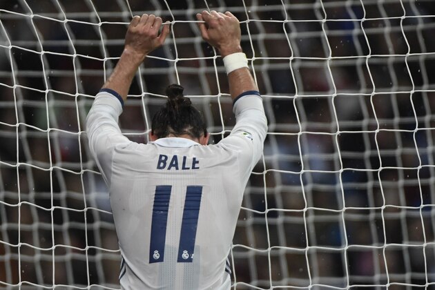 TOPSHOT - Real Madrid's Welsh forward Gareth Bale grabs the goal's net during the Spanish league football match between Real Madrid CF and Athletic Club Bilbao at the Santiago Bernabeu stadium in Madrid on October 23, 2016. / AFP / CURTO DE LA TORRE        (Photo credit should read CURTO DE LA TORRE/AFP/Getty Images)