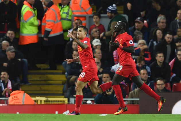 Liverpool's Brazilian midfielder Philippe Coutinho (L) celebrates scoring their second goal with Liverpool's Senegalese midfielder Sadio Mane (R) during the English Premier League football match between Liverpool and West Bromwich Albion at Anfield in Liverpool, north west England on October 22, 2016. / AFP / PAUL ELLIS / RESTRICTED TO EDITORIAL USE. No use with unauthorized audio, video, data, fixture lists, club/league logos or 'live' services. Online in-match use limited to 75 images, no video emulation. No use in betting, games or single club/league/player publications.  /         (Photo credit should read PAUL ELLIS/AFP/Getty Images)