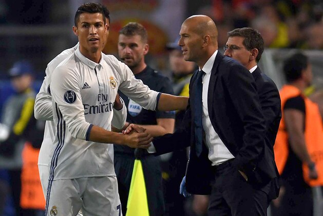 Real Madrid's Portuguese forward Cristiano Ronaldo (L) celebrates after his goal with Real Madrid's French coach Zinedine Zidane during the UEFA Champions League first leg football match between Borussia Dortmund and Real Madrid at BVB stadium in Dortmund, on September 27, 2016. / AFP / PATRIK STOLLARZ        (Photo credit should read PATRIK STOLLARZ/AFP/Getty Images)