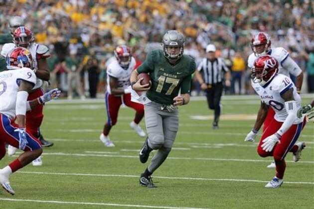 Baylor quarterback Seth Russell (17) runs the ball as Kansas safety Fish Smithson (9) and cornerback Marnez Ogletree (10) give chase during an NCAA college football game, Saturday, Oct. 15, 2016, in Waco, Texas. (AP Photo/Tony Gutierrez)