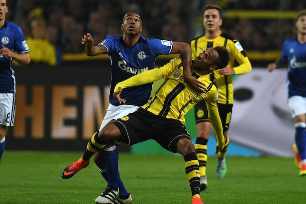 Dortmund's Gabonese striker Pierre-Emerick Aubameyang and Schalke's Brazilian defender  Naldo vie for the ball during the German first division Bundesliga football match between Borussia Dortmund and FC Schalke 04 in Dortmund on October 29, 2016. / AFP / PATRIK STOLLARZ / RESTRICTIONS: DURING MATCH TIME: DFL RULES TO LIMIT THE ONLINE USAGE TO 15 PICTURES PER MATCH AND FORBID IMAGE SEQUENCES TO SIMULATE VIDEO. == RESTRICTED TO EDITORIAL USE == FOR FURTHER QUERIES PLEASE CONTACT DFL DIRECTLY AT + 49 69 650050
        (Photo credit should read PATRIK STOLLARZ/AFP/Getty Images)