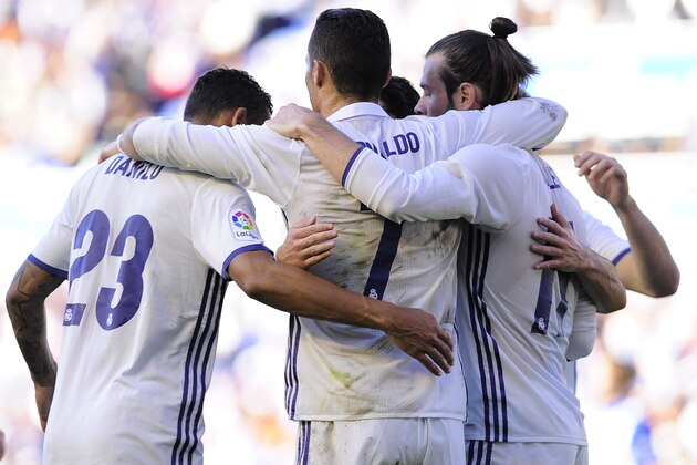 Real Madrid's Portuguese forward Cristiano Ronaldo (C) is congratulated by teammates after scoring his team's second goal during the Spanish league football match between Deportivo Alaves and Real Madrid CF at the Mendizorroza stadium in Vitoria on October 29, 2016. / AFP / ANDER GILLENEA        (Photo credit should read ANDER GILLENEA/AFP/Getty Images)